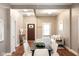 Inviting open-concept living space with a dark wood front door, hardwood floors, and neutral decor at 940 E Pleasant Run Parkway North Dr, Indianapolis, IN 46203
