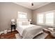 Serene main bedroom with soft lighting, neutral walls, and a comfortable bed with plush bedding at 940 E Pleasant Run Parkway North Dr, Indianapolis, IN 46203