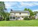 Expansive backyard featuring lush green lawn and a bright sunroom, ideal for outdoor enjoyment and relaxation at 9583 Greenthread Dr, Zionsville, IN 46077