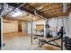 Unfinished basement with exposed ceiling, workout equipment, and room for storage at 9583 Greenthread Dr, Zionsville, IN 46077