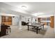 Expansive finished basement featuring ping pong table, home theater, and custom shelving at 9583 Greenthread Dr, Zionsville, IN 46077