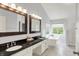 Elegant bathroom with double vanities, a soaking tub, and a separate glass shower at 9583 Greenthread Dr, Zionsville, IN 46077