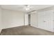 Bright bedroom with a ceiling fan, plush carpet, and a double door closet at 9583 Greenthread Dr, Zionsville, IN 46077