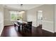 Dining area with hardwood floors, table with bench seating, and access to kitchen at 9583 Greenthread Dr, Zionsville, IN 46077