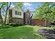 Beautiful brick home with manicured lawn, complemented by lush greenery and a welcoming entrance at 9583 Greenthread Dr, Zionsville, IN 46077