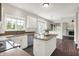Bright kitchen with white cabinets, stainless steel appliances, hardwood floors and an island at 9583 Greenthread Dr, Zionsville, IN 46077