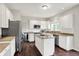Spacious kitchen with white cabinets, stainless steel appliances, a center island and hardwood floors at 9583 Greenthread Dr, Zionsville, IN 46077