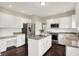 Kitchen with granite countertops, stainless steel appliances, white cabinetry and hardwood floors at 9583 Greenthread Dr, Zionsville, IN 46077