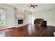 Spacious living room with brick fireplace, hardwood floors, and a large window with natural light at 9583 Greenthread Dr, Zionsville, IN 46077