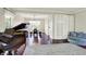 Open-concept living and dining area featuring hardwood floors, a piano, and large windows at 9583 Greenthread Dr, Zionsville, IN 46077