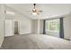 Bright main bedroom with a ceiling fan, a walk-in closet, and a large window at 9583 Greenthread Dr, Zionsville, IN 46077