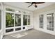 Enclosed sun room with large windows and a ceiling fan at 9583 Greenthread Dr, Zionsville, IN 46077