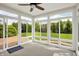 Bright sun room with large windows offering views of the landscaped backyard at 9583 Greenthread Dr, Zionsville, IN 46077