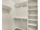 Walk-in closet featuring built-in shelves and hanging rods for efficient organization at 9583 Greenthread Dr, Zionsville, IN 46077