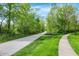 Picturesque walking path surrounded by mature trees, offering a serene environment for exercise and leisure at 9583 Greenthread Dr, Zionsville, IN 46077