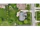 Aerial view of a well-maintained home with a large yard, patio, and surrounding trees at 9749 Soaring Eagle Ln, Fishers, IN 46055