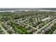 Stunning aerial view of a lakeside neighborhood featuring manicured lawns, tree-lined streets, and beautiful homes with water views at 9749 Soaring Eagle Ln, Fishers, IN 46055