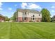 Well manicured backyard featuring a stone fire pit and an outdoor seating area at 9749 Soaring Eagle Ln, Fishers, IN 46055