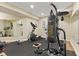 Finished basement gym with rubber flooring, workout equipment, and mirrored wall at 9749 Soaring Eagle Ln, Fishers, IN 46055