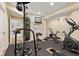 Finished basement gym with rubber flooring, workout equipment, and mirrored wall at 9749 Soaring Eagle Ln, Fishers, IN 46055
