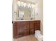 Bathroom featuring double sinks, wood cabinets, and neutral countertops at 9749 Soaring Eagle Ln, Fishers, IN 46055