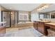 Bright bathroom with a walk-in shower, soaking tub, and spacious vanity area, offering a spa-like experience at 9749 Soaring Eagle Ln, Fishers, IN 46055
