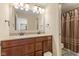Bathroom with double sink vanity, large mirror, and a shower with curtain at 9749 Soaring Eagle Ln, Fishers, IN 46055