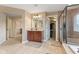 Bathroom featuring a walk-in shower, vanity, and access to a walk-in closet, blending functionality with style at 9749 Soaring Eagle Ln, Fishers, IN 46055