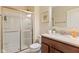 Well-lit bathroom featuring a glass-enclosed shower and a vanity with a neutral countertop at 9749 Soaring Eagle Ln, Fishers, IN 46055
