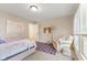 Bright bedroom offers a cozy chair and patterned rug at 9749 Soaring Eagle Ln, Fishers, IN 46055
