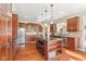 Beautiful kitchen features dark wood cabinetry, a granite countertop island, and stainless steel appliances at 9749 Soaring Eagle Ln, Fishers, IN 46055
