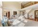 Open-concept living room featuring high ceilings, a fireplace, and staircase at 9749 Soaring Eagle Ln, Fishers, IN 46055