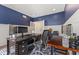 Beautiful office features stylish blue walls, white wainscoting and modern decor at 9749 Soaring Eagle Ln, Fishers, IN 46055