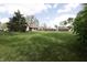 Large backyard with mature trees, a storage shed, and ample space for outdoor activities at 9903 E Raymond St, Indianapolis, IN 46239