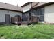 Backyard showing a wooden deck, screened porch, and grassy lawn at 9903 E Raymond St, Indianapolis, IN 46239