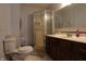 Bathroom featuring a toilet, shower with glass doors, tile floors, and vanity at 9903 E Raymond St, Indianapolis, IN 46239