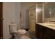 Bathroom featuring a toilet, shower with glass doors, tile floors, and vanity with drawers at 9903 E Raymond St, Indianapolis, IN 46239