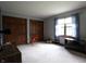 Spacious bedroom features two closets with dark wood doors, a window with curtains, and neutral paint at 9903 E Raymond St, Indianapolis, IN 46239