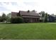 Charming brick home with a well-manicured lawn and inviting front entrance at 9903 E Raymond St, Indianapolis, IN 46239