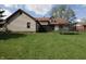A spacious backyard featuring a home with a screened porch and a trampoline at 9903 E Raymond St, Indianapolis, IN 46239