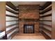 Rustic fireplace with brick surround and custom built-in shelving, adding charm to the space at 9903 E Raymond St, Indianapolis, IN 46239