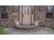 Inviting front entrance with brick steps and decorative planters, creating curb appeal at 9903 E Raymond St, Indianapolis, IN 46239