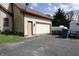 A detached two-car garage with an adjacent side door and a paved driveway at 9903 E Raymond St, Indianapolis, IN 46239