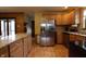 Updated kitchen features stainless steel appliances, granite countertops, wood cabinets, and an island with a granite countertop at 9903 E Raymond St, Indianapolis, IN 46239