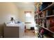 Laundry room with washer, dryer, shelving, and vinyl floor at 9903 E Raymond St, Indianapolis, IN 46239