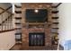 Cozy living room with fireplace and shelving, ideal for entertaining and relaxation at 9903 E Raymond St, Indianapolis, IN 46239