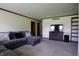 Cozy living room featuring a comfortable gray sectional sofa and modern entertainment center at 9903 E Raymond St, Indianapolis, IN 46239