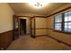 Room with French doors, a window with blinds, neutral paint, and carpet at 9903 E Raymond St, Indianapolis, IN 46239