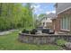 Beautiful backyard featuring a stone patio with fire pit and outdoor seating area at 9950 Sugarleaf Pl, Fishers, IN 46038