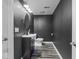 Modern bathroom with sleek fixtures, dark walls, and stylish tile flooring at 9950 Sugarleaf Pl, Fishers, IN 46038